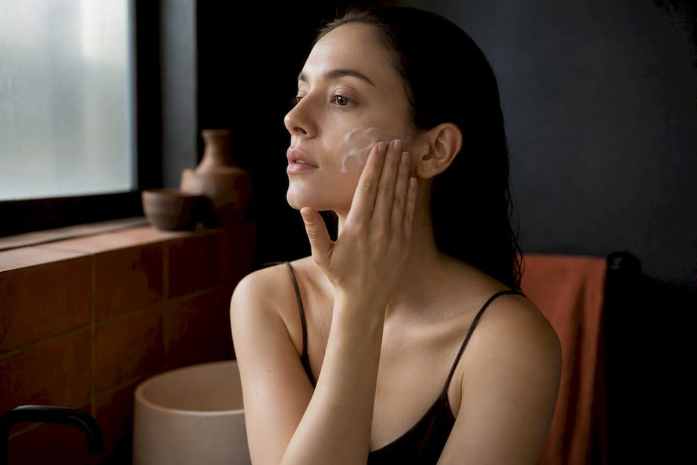 Hands applying moisturizer to calm skin