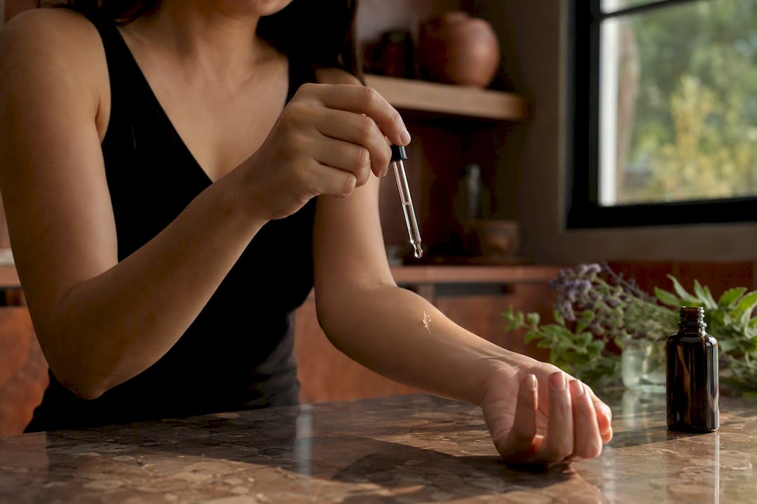 Close-up of hand applying peptide serum