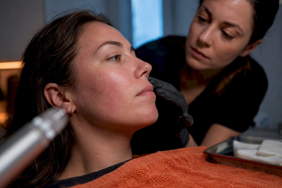 Practitioner assessing skin after microneedling