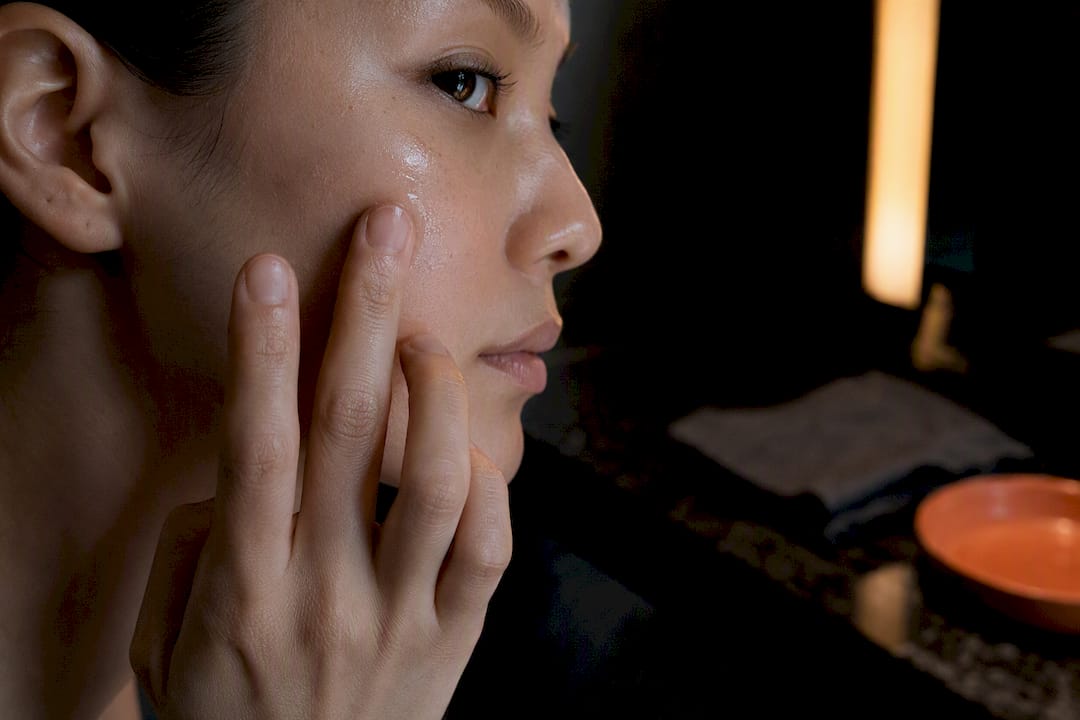 Person applying serum in minimalist skincare routine