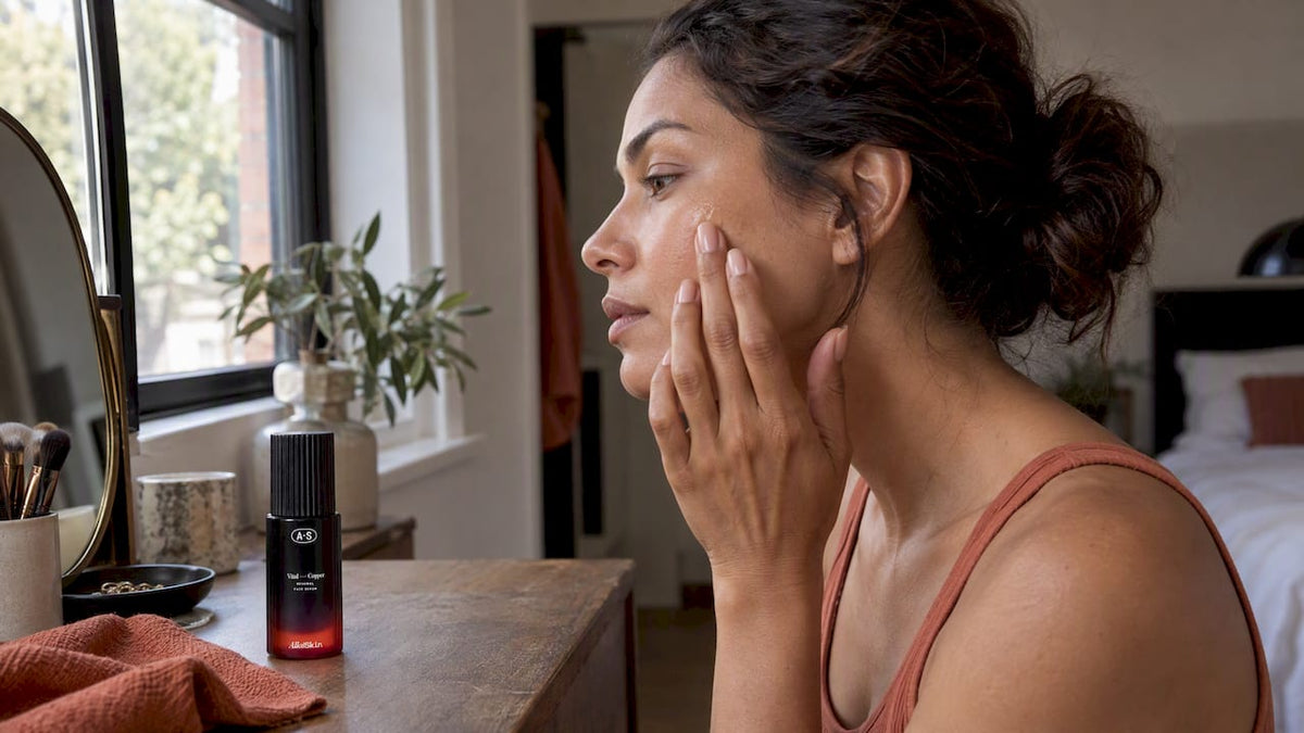 Woman applying peptide serum beside its bottle